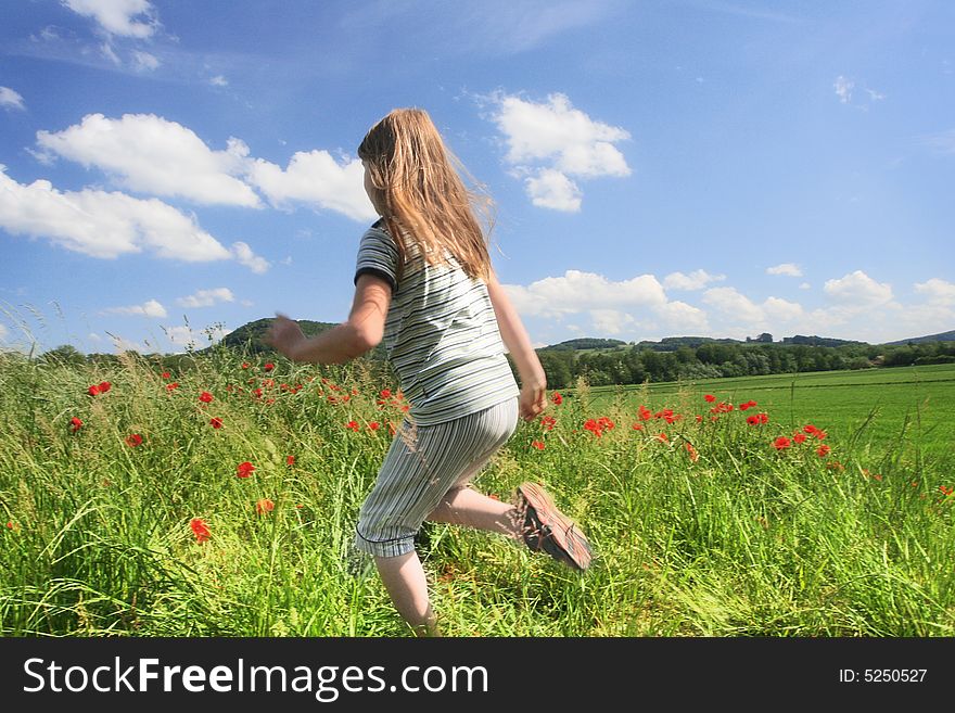 Happy child run on the field with red poppies. Happy child run on the field with red poppies