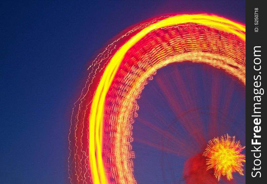 Image of a spinning wheel in an amusement park, long exposure