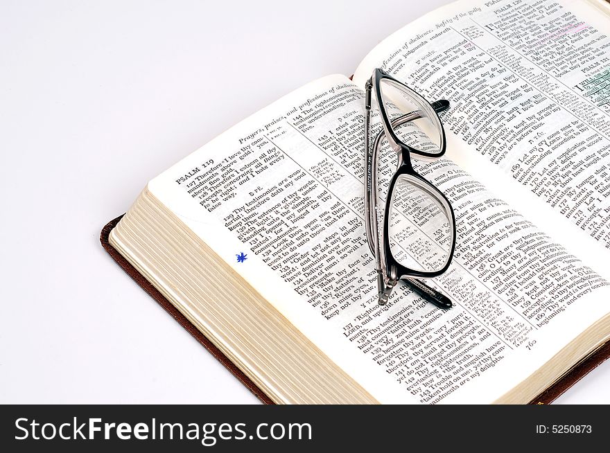 A bible with a pair of glasses. A bible with a pair of glasses