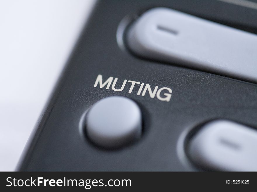 Close up of a mute button on a remote control