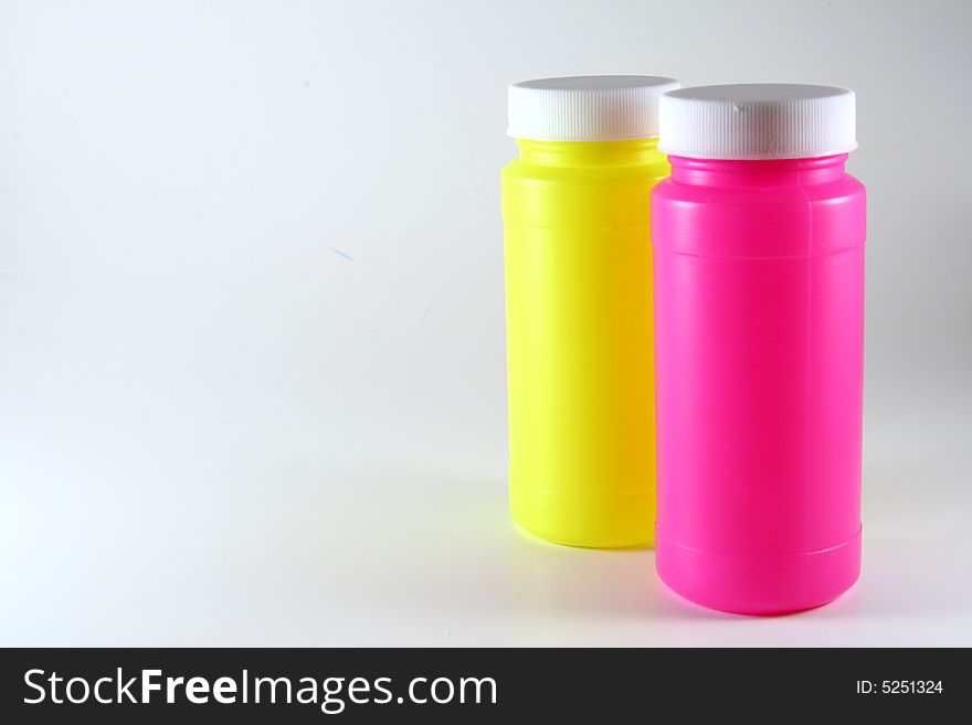 Two colorful bottles on white.