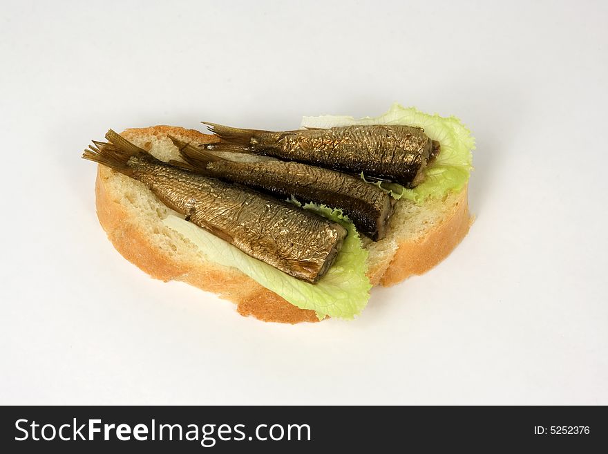 Open sandwich with a kipper and leaves of lettuce