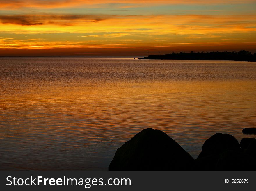 Silent sunset on balic sea with yellow clouds like a ribbons. Silent sunset on balic sea with yellow clouds like a ribbons