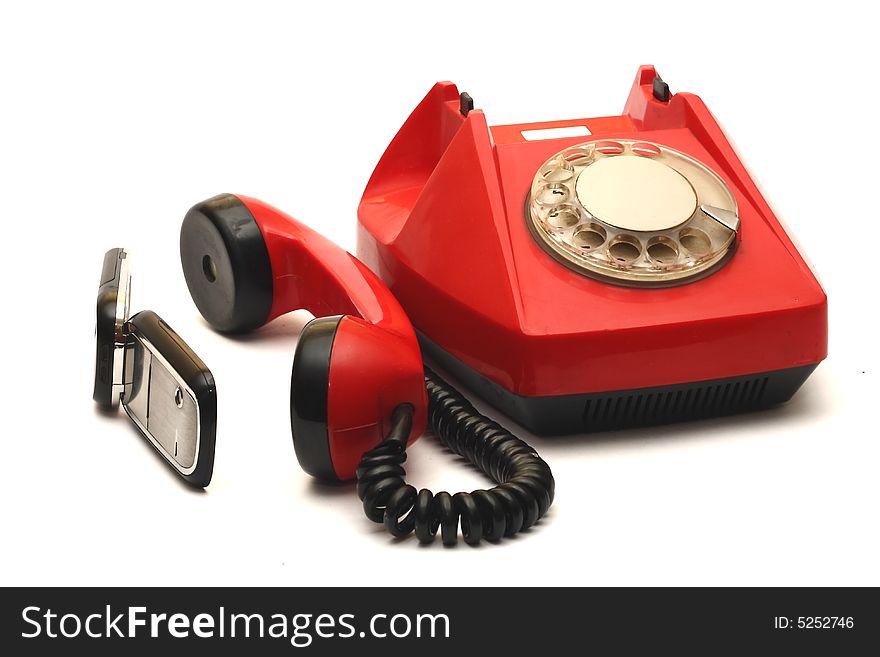 Cellular telephone and red wire telephone on white background. Cellular telephone and red wire telephone on white background