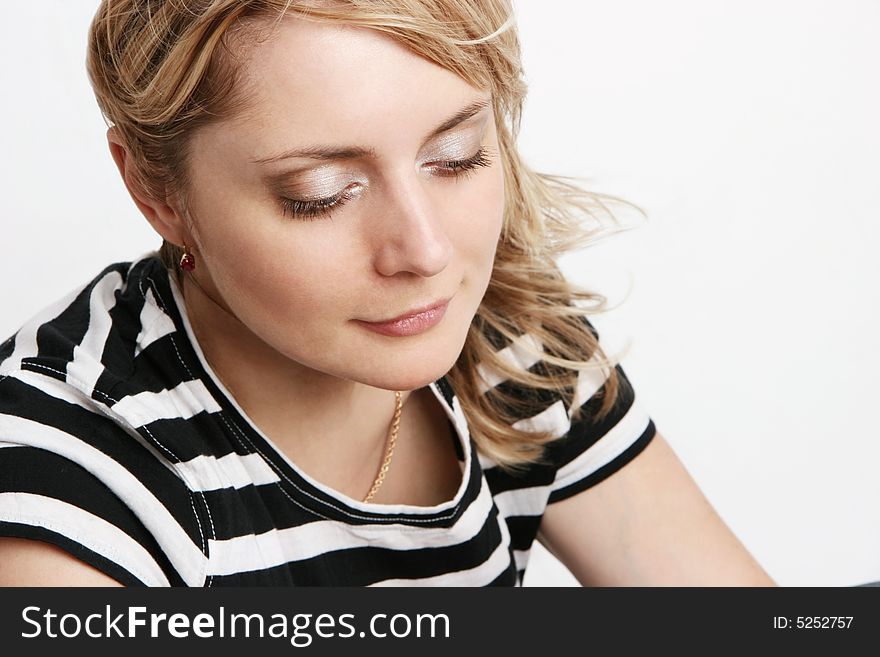 A portrait of a smiling girl. Light background. A portrait of a smiling girl. Light background.