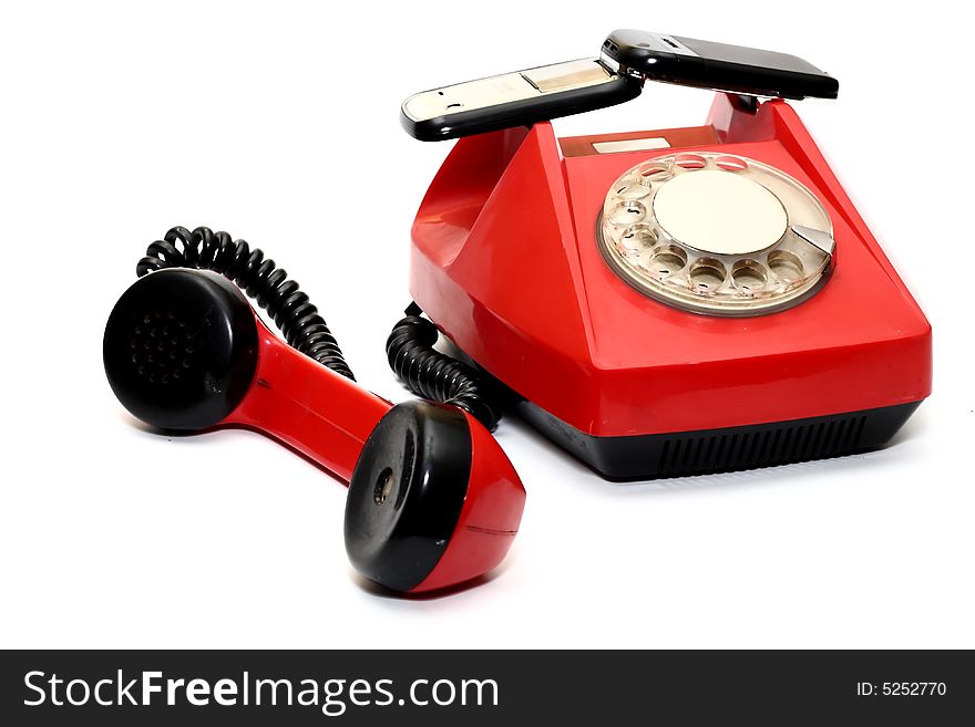 Cellular telephone on red wire telephone on white background