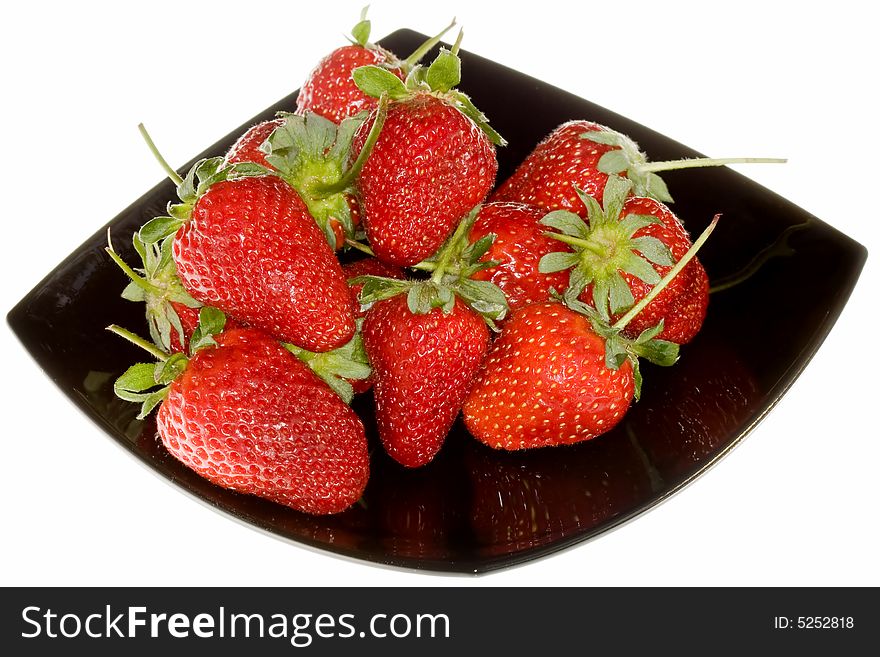 Delicious strawberries on black plate