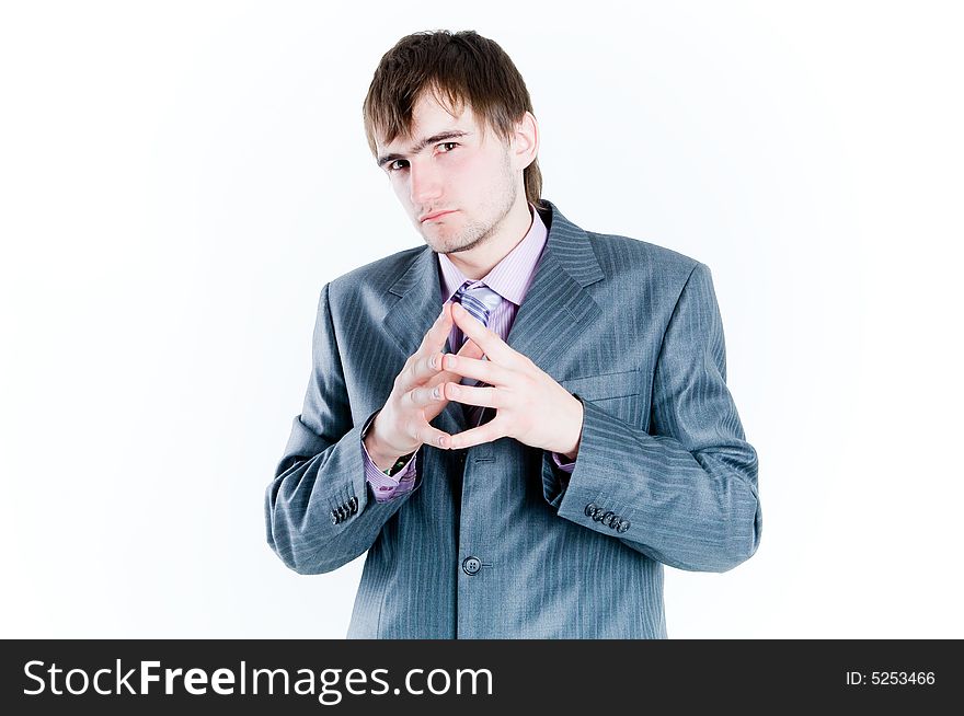 Serious businessman with hands clasped together