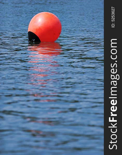 Orange buoy in the blue water. Orange buoy in the blue water.