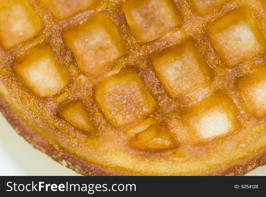 A pair of golden brown toasted waffles ready for eating.