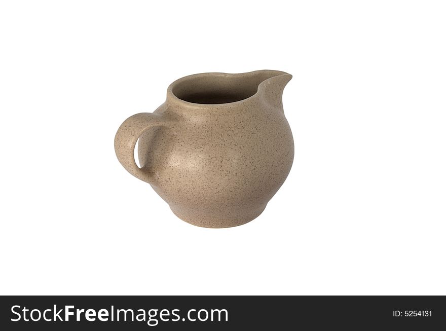 Brown small ceramic cream-jug of the coffee set isolated over white