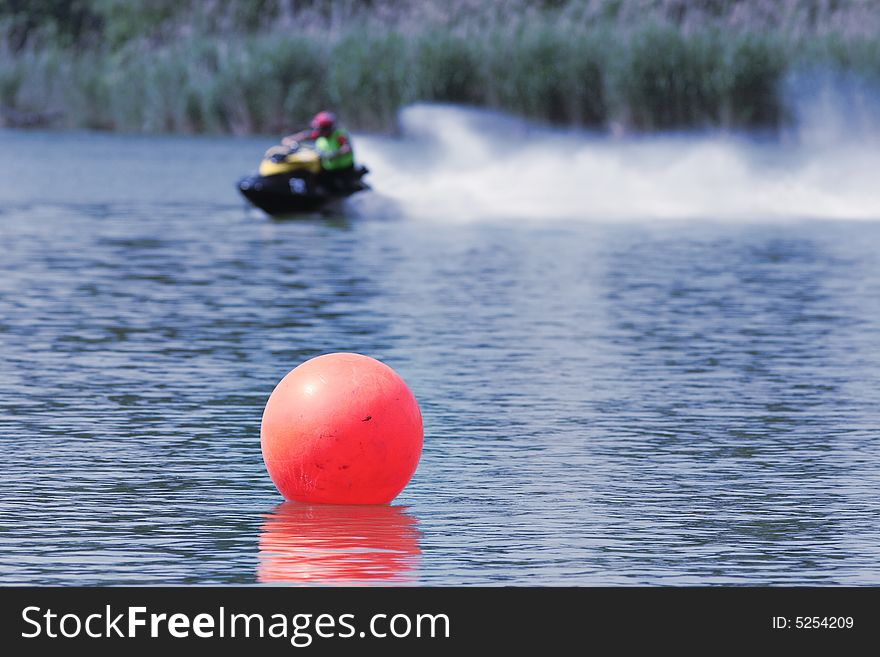 Orange buoy and aqua bike at the lake. Orange buoy and aqua bike at the lake.
