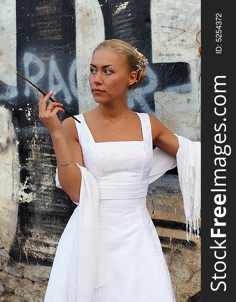 The bride in a wedding dress and with a cigarette. The bride in a wedding dress and with a cigarette