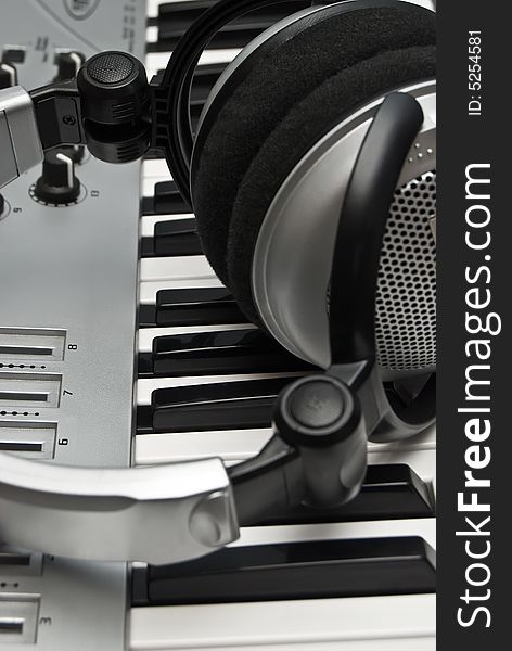 Grey modern piano and headphones.