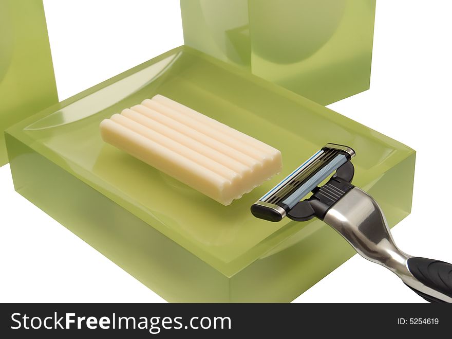 Razor and soap on a white background