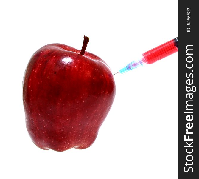 Syringe on a fresh and juicy red apple
