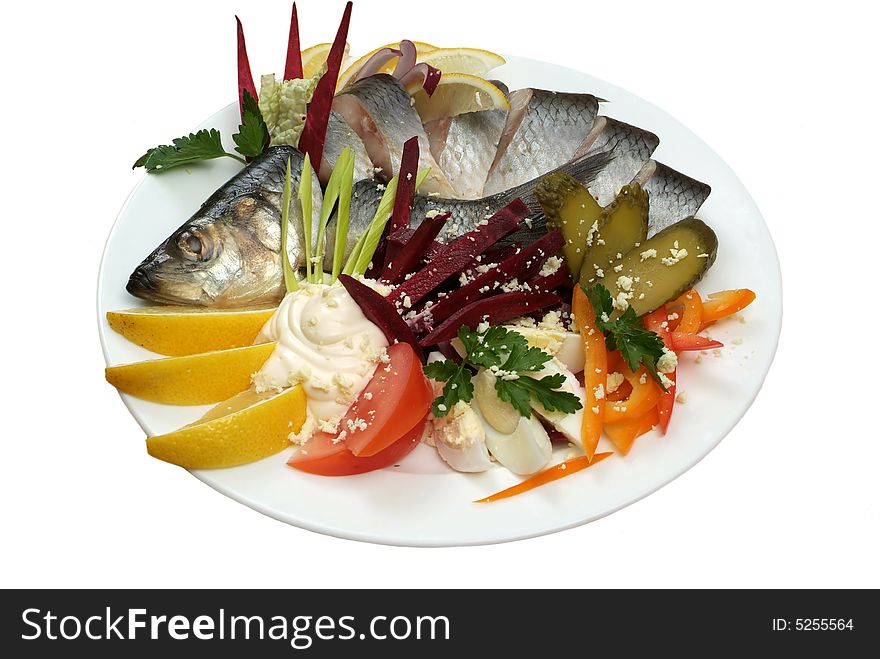Salad from a salty herring with vegetables and a lemon