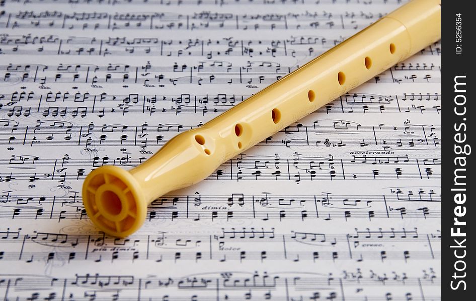 Flute on a music sheet with notes