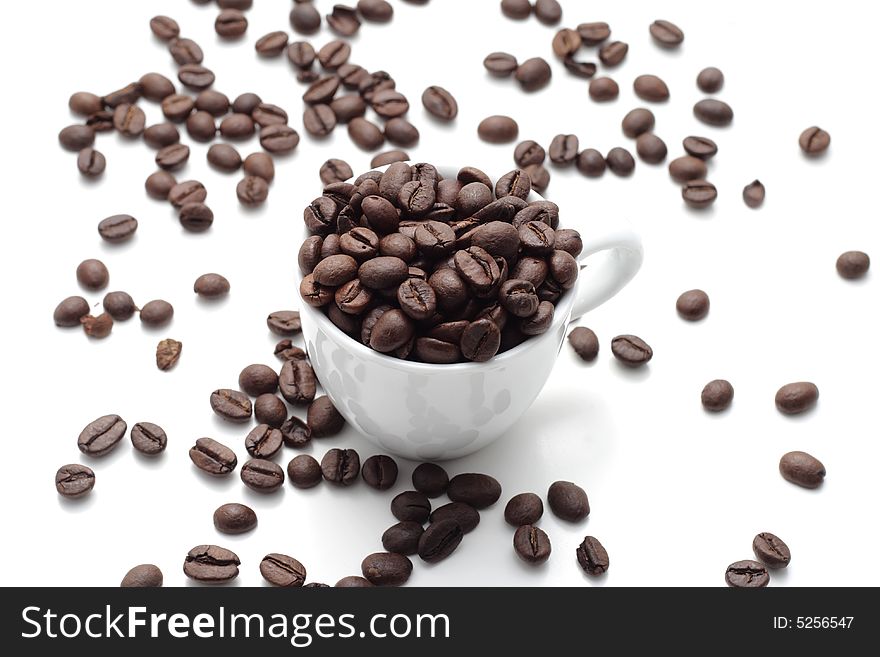 Coffee seed in a cup isolated on a white background