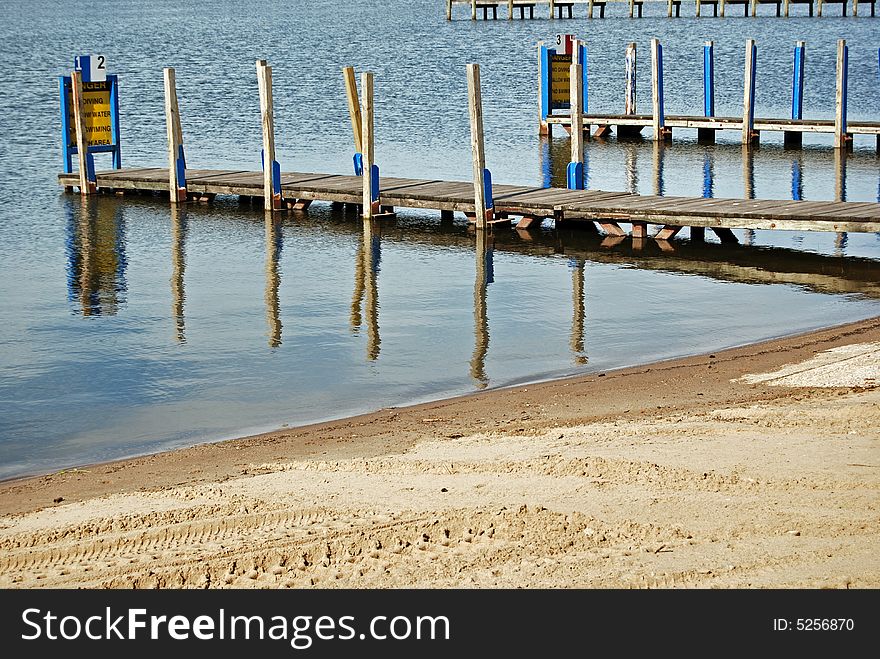 Pair of vacant boat ramps extending in the water.