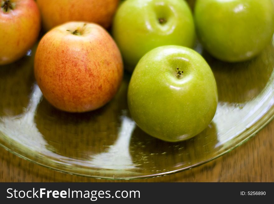 Red and green apples on a plate