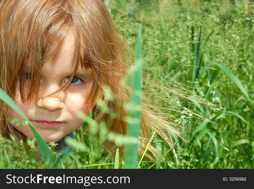 Portrait of a little sitting in grass little girl. Portrait of a little sitting in grass little girl