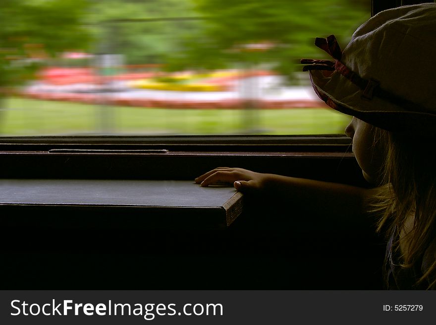 3 year old girl looking into the window in the train. 3 year old girl looking into the window in the train