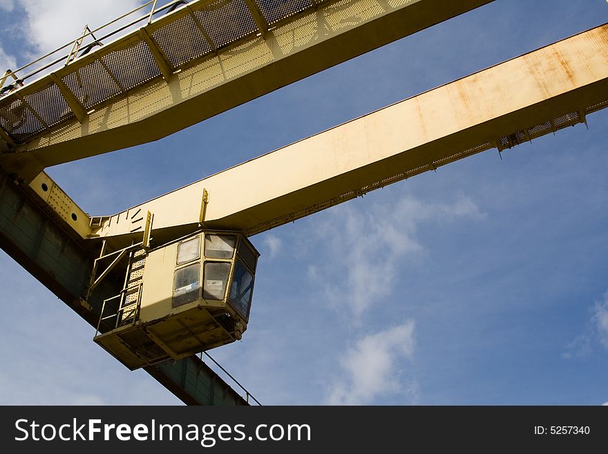 Industrial crane with sky in the background