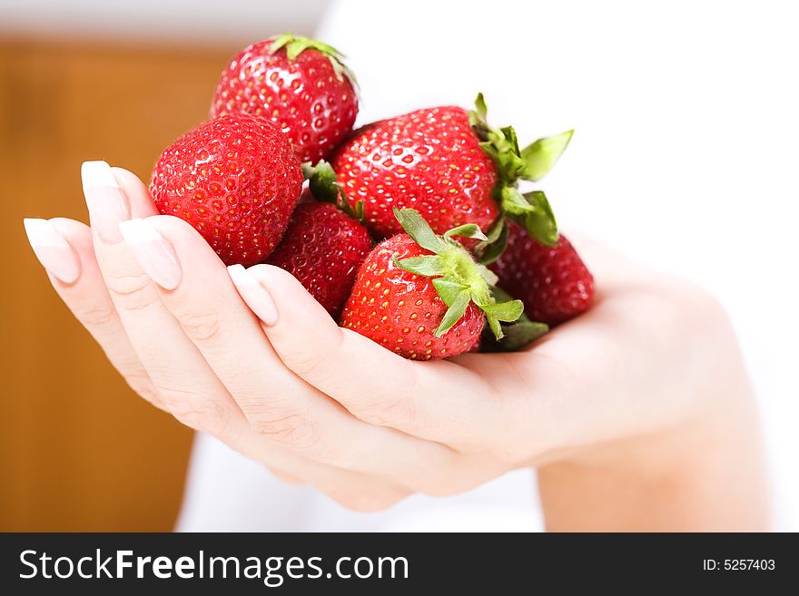 Beautiful hand with French manicure and fresh strawberry. Soft-focused, low DOF. Beautiful hand with French manicure and fresh strawberry. Soft-focused, low DOF