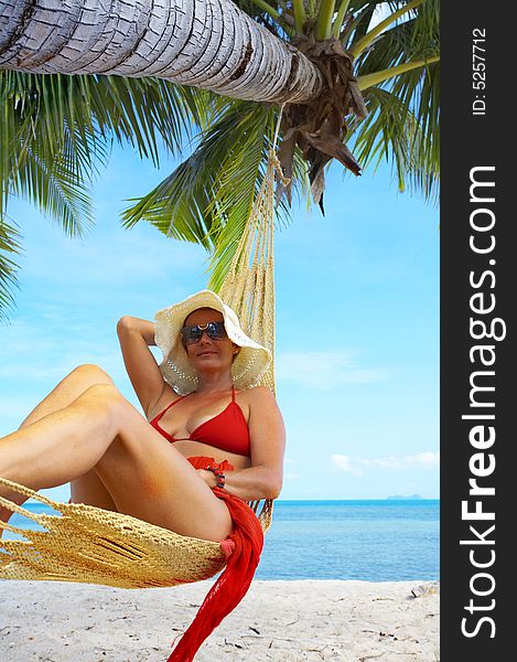 View of nice woman lounging in hammock in tropical environment. View of nice woman lounging in hammock in tropical environment