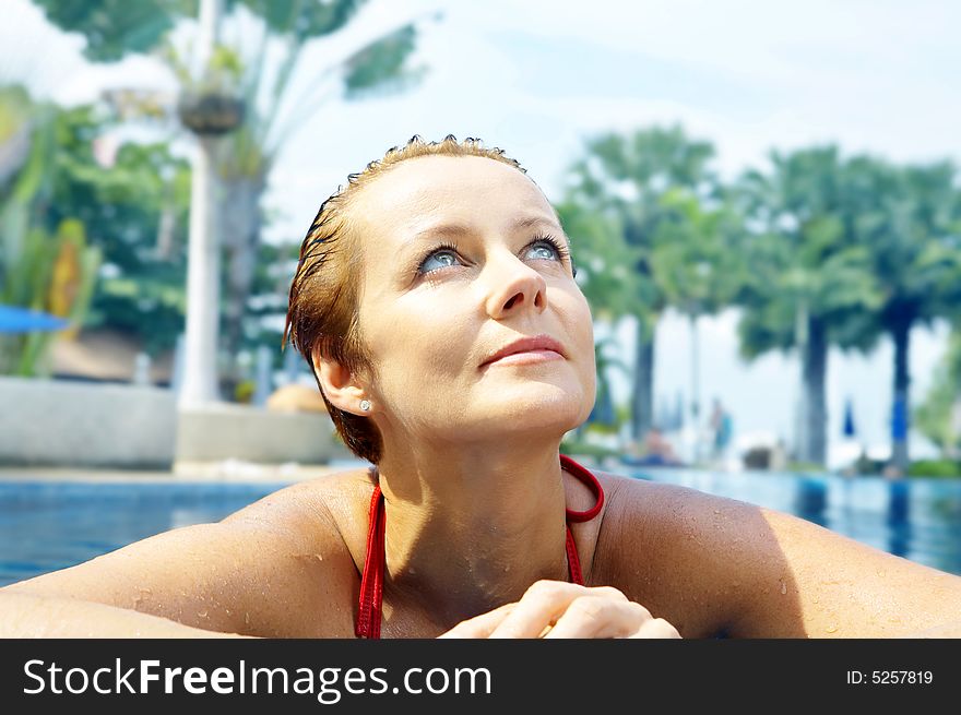 Portrait of nice young woman relaxing in swimming pool. Portrait of nice young woman relaxing in swimming pool