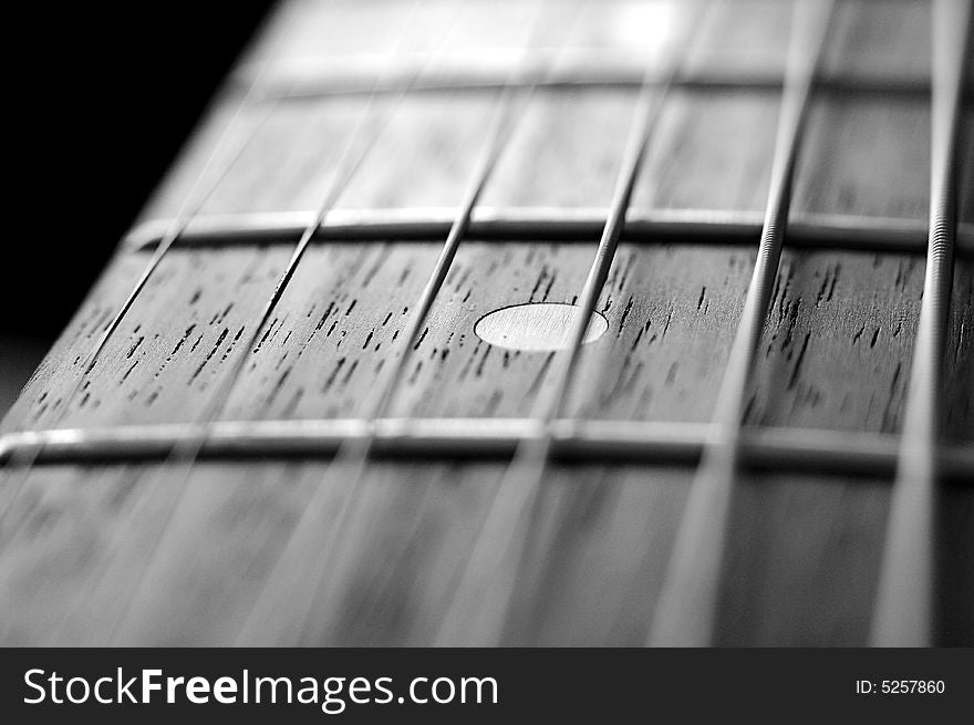 A macro shot of a guitar neck.