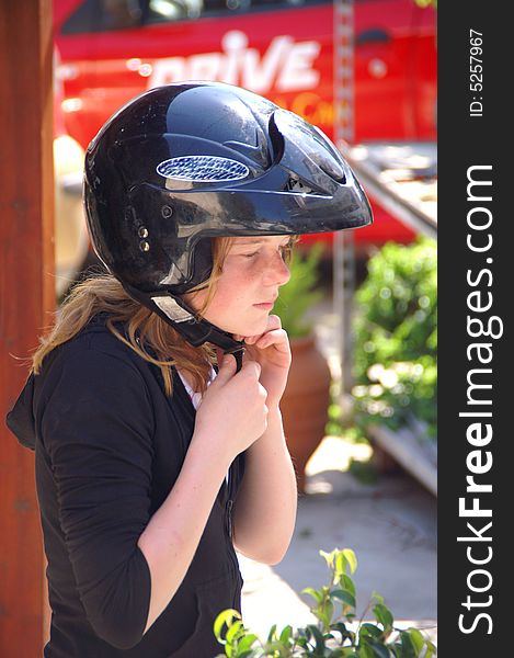 Young girl wearing a helmet. Young girl wearing a helmet