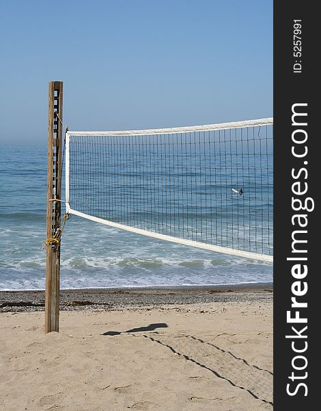 Beach volleyball court with ocean in the backround..