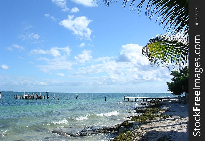 Seascape with shoreline and wooden jetty. Seascape with shoreline and wooden jetty.