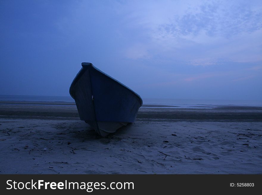 A fisherman's sampan at the beach in the morning. A fisherman's sampan at the beach in the morning.