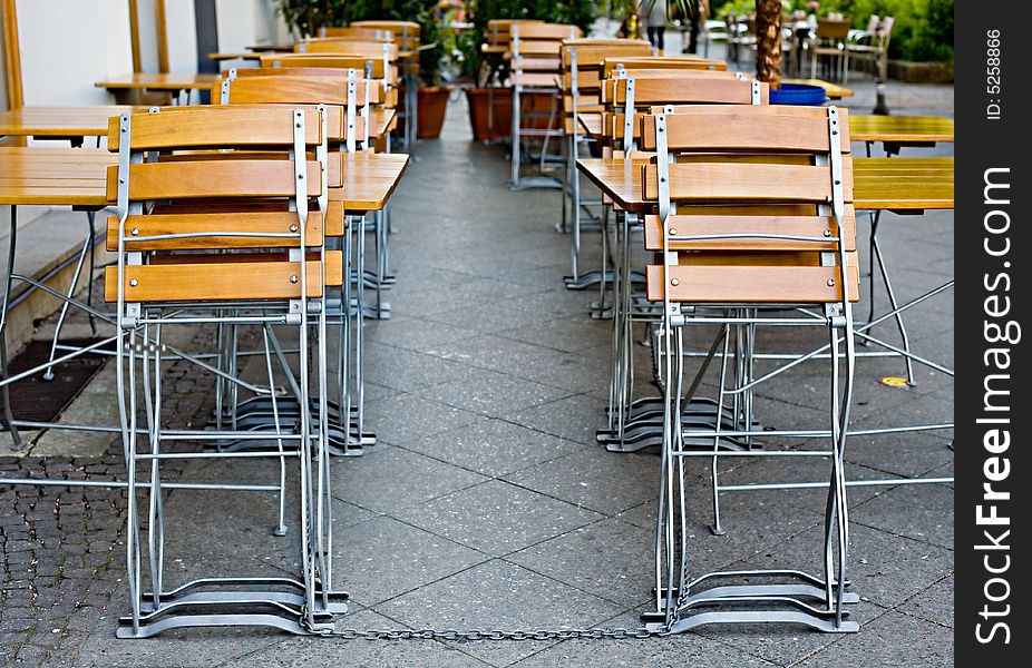 Small empty summer cafe with collapsible wooden chairs and tables. Small empty summer cafe with collapsible wooden chairs and tables