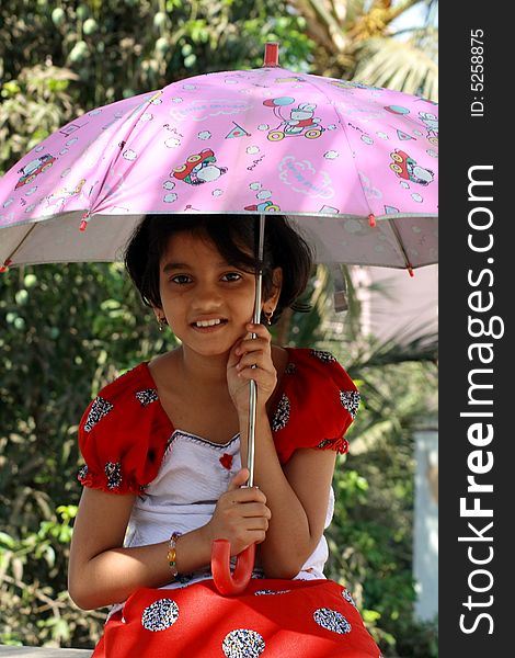 A girl with her pink umbrella. A girl with her pink umbrella.