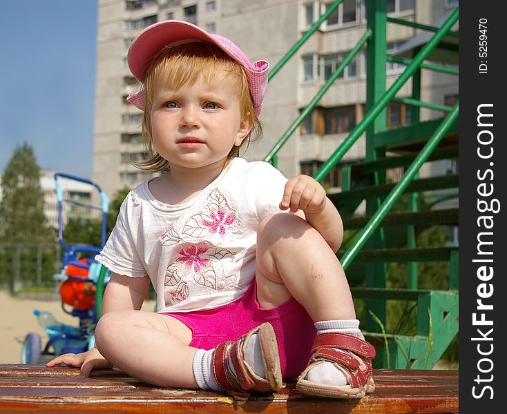 Cute Girl Sits On A Bench