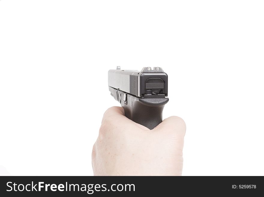 A Hand Holds A Handgun Isolated On White