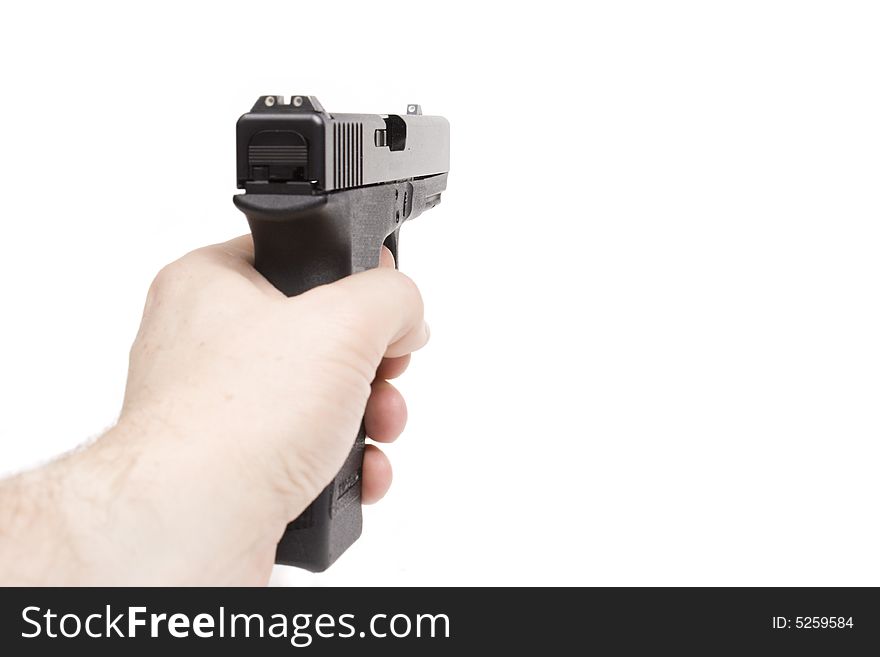 A hand is holding a handgun, isolated on white background. A hand is holding a handgun, isolated on white background