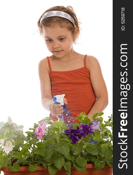 Young girl watering a flower in flowerpot