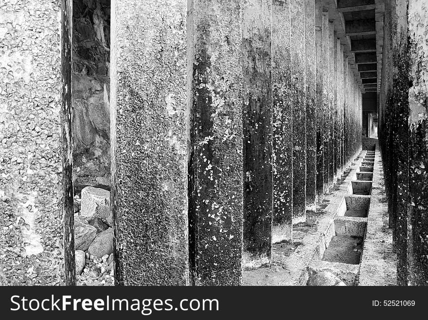 Corridor of concrete pillars with perspective depth black and white. Corridor of concrete pillars with perspective depth black and white