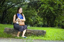 Happy Woman Sitting On Log With Blue Fan Stock Photography Happy Woman Sitting On Log With Blue Fan Stock Photography