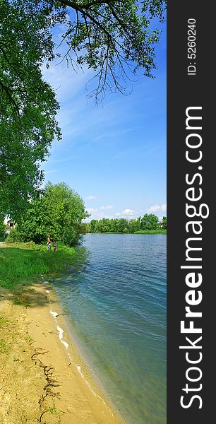 Lakeside with tree, green grass, path and nice blue sky. Lakeside with tree, green grass, path and nice blue sky