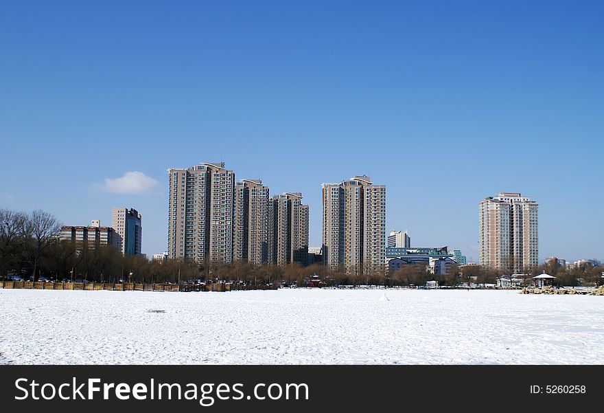 City with snow under blue sky in winter
