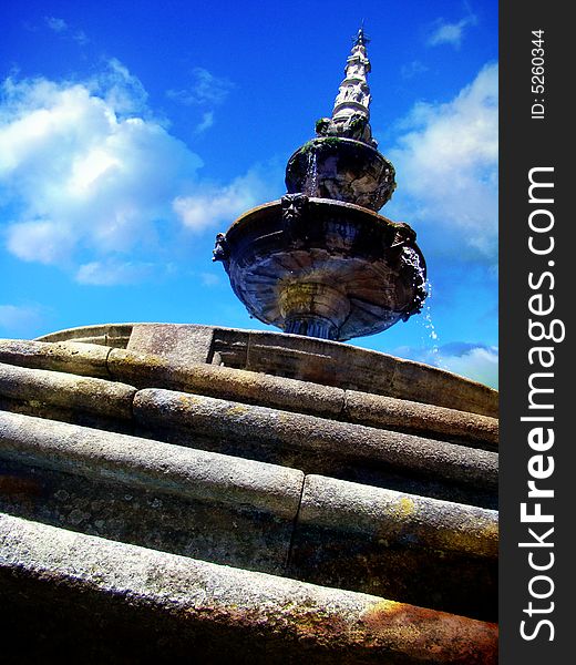 Old mystic fountain under blue sky