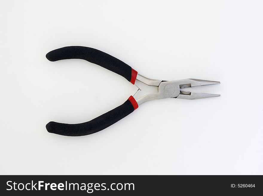 A pair of long nosed pliers, chromed with black rubber handles. A pair of long nosed pliers, chromed with black rubber handles