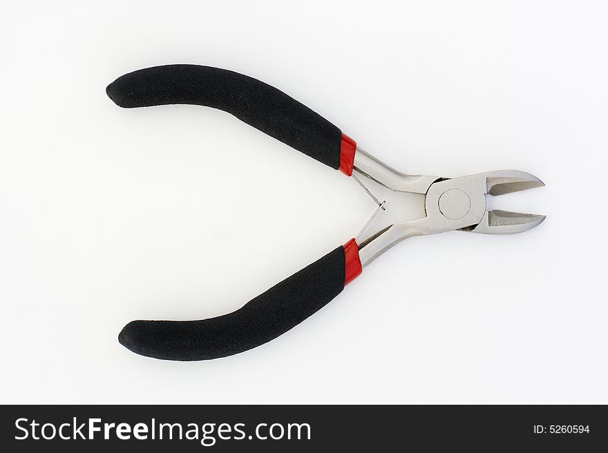 A pair of side cutting pliers, chromed with black rubber handles. A pair of side cutting pliers, chromed with black rubber handles