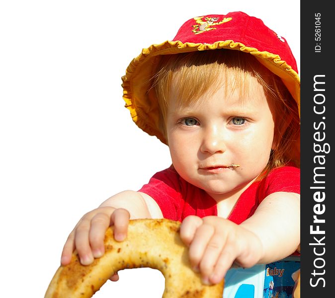 The little girl eats a bagel on a white background. The little girl eats a bagel on a white background